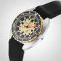 A close-up of the DOXA Army Bronze watch by DOXA, featuring a beige dial, black and white Super-LumiNova® markers, orange hands, a date window, and a black strap.