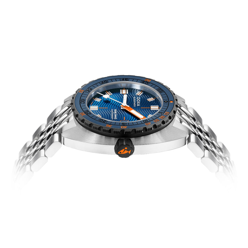 Side view of the DOXA Sub 300 Beta Caribbean, a water-resistant stainless steel sports watch with a blue and orange dial, silver bracelet, and black ceramic bezel, photographed on a white background.