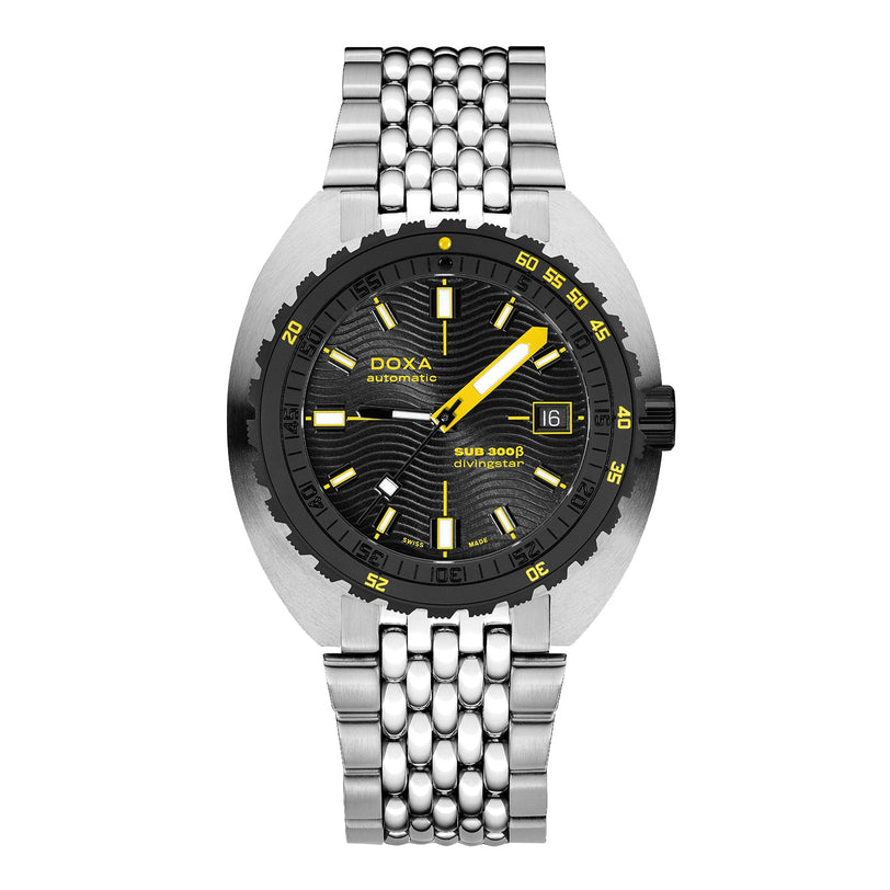 The DOXA Sub 300 Beta Divingstar is a sports watch with a black dial, yellow accents, date at 3 o’clock, black ceramic bezel, stainless steel bracelet, and Swiss automatic movement.