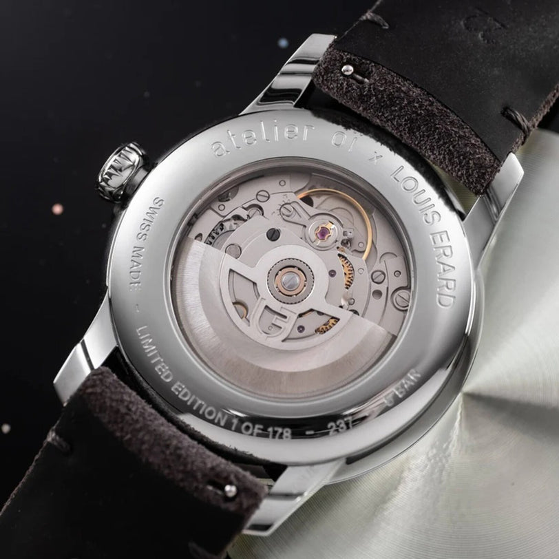 Close-up of the Le Régulateur Louis Erard x atelier oï by Louis Erard, highlighting its transparent case back with intricate mechanical movement and detailed engravings.