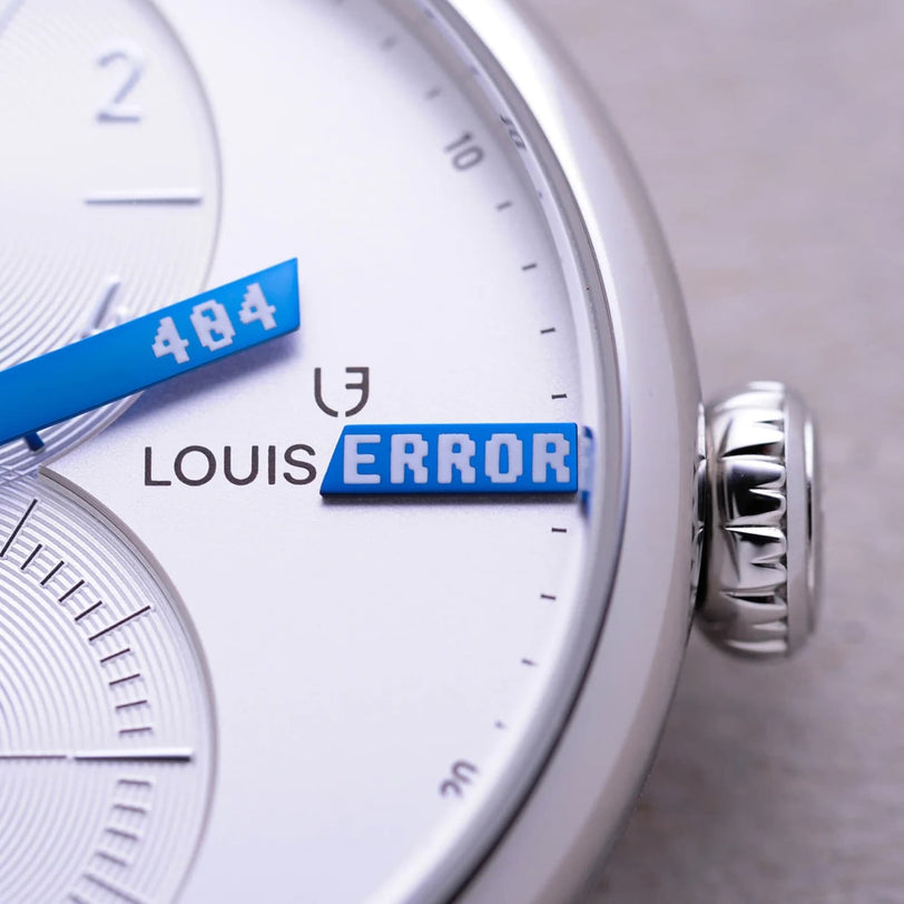 Close-up of the Le Régulateur Louis Erard x seconde/seconde/ watch face with blue hands, featuring 404 and ERROR over the Louis Erard logo.