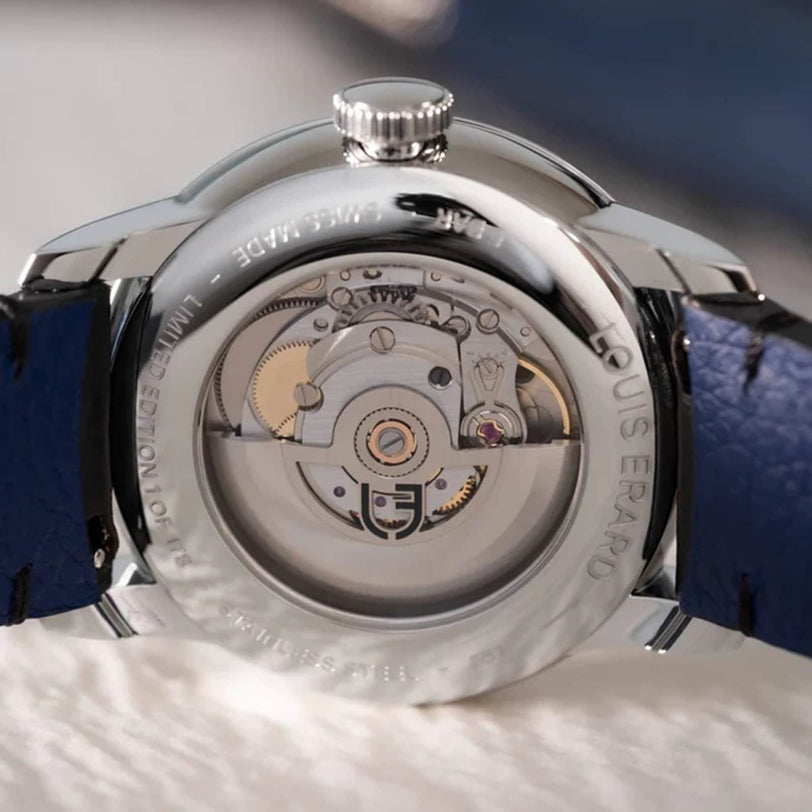 Close-up of the Louis Erard Le Régulateur x Massena LAB Gold’s transparent case back, revealing its intricate mechanical movement and gears.