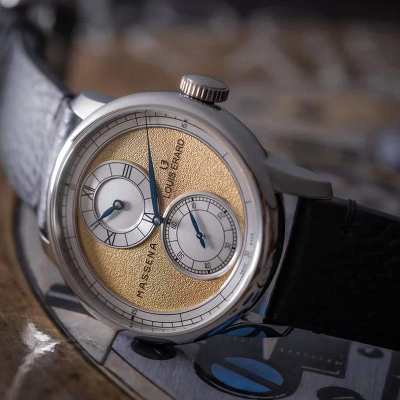 Close-up of the Louis Erard Le Régulateur x Massena LAB Gold, featuring a gold-textured dial, two subdials, and a black leather strap.
