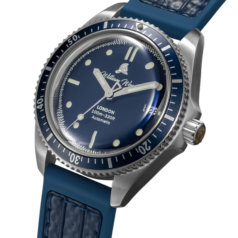The Valiant Collection - The Blue Watch by William Wood features a blue dial, a rotating bezel, a leather strap, displays the time 10:10, and is labeled William Wood.
