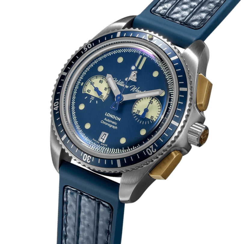 The William Wood Triumph Collection - Oxygen Edition is a blue luxury wristwatch featuring a stainless steel case, textured strap, and gold accents on the crown and pushers.