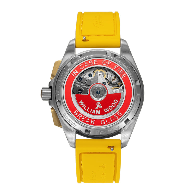 Back of a William Wood Triumph Collection - Fuel Edition watch with a yellow strap and red label reading In Case of Fire Break Glass.