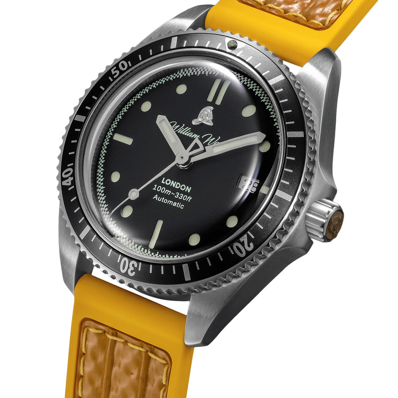 The William Wood Valiant Collection - The Black Watch is a luxury dive watch featuring a black dial, silver bezel, yellow strap, and date display at 3 oclock.
