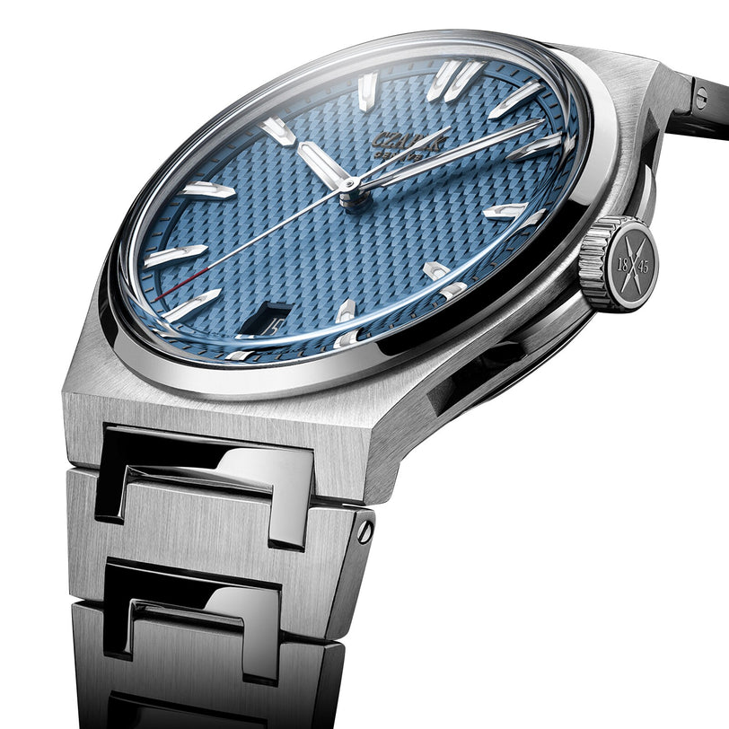 The Czapek Antarctique Passage de Drake Glacier Blue, featuring a textured blue dial and metallic bracelet, is displayed at an angle.