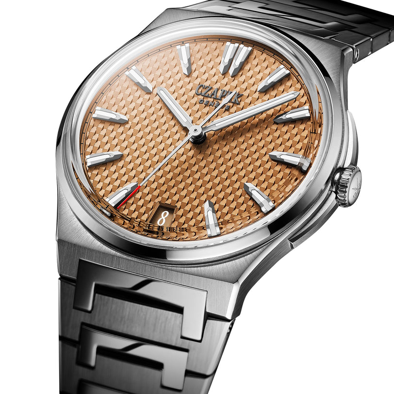 The Czapek Antarctique Passage de Drake Salmon S features a metallic bracelet, date display at 6 o’clock, and a textured copper dial.