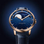 The Arnold & Son Perpetual Moon 41.5mm Red Gold features a blue starry sky dial, moon phase display, and a gold case paired with a blue leather strap.