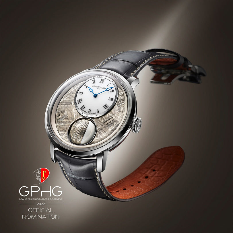 The Arnold & Son Luna Magna Platinum wristwatch features a textured dial, leather strap, and displays the official GPHG 2022 nomination badge beside it.
