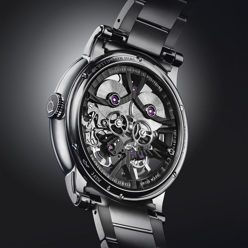 A close-up of the Arnold & Son Nebula 41.5 Steel luxury skeleton watch highlights its visible gears and intricate mechanical details.