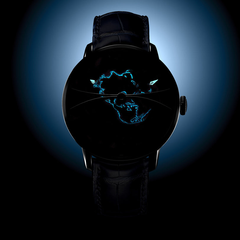 The Arnold & Son Globetrotter Steel is a black wristwatch with a glowing blue map of Africa on its dark face, displayed against a blue gradient background.