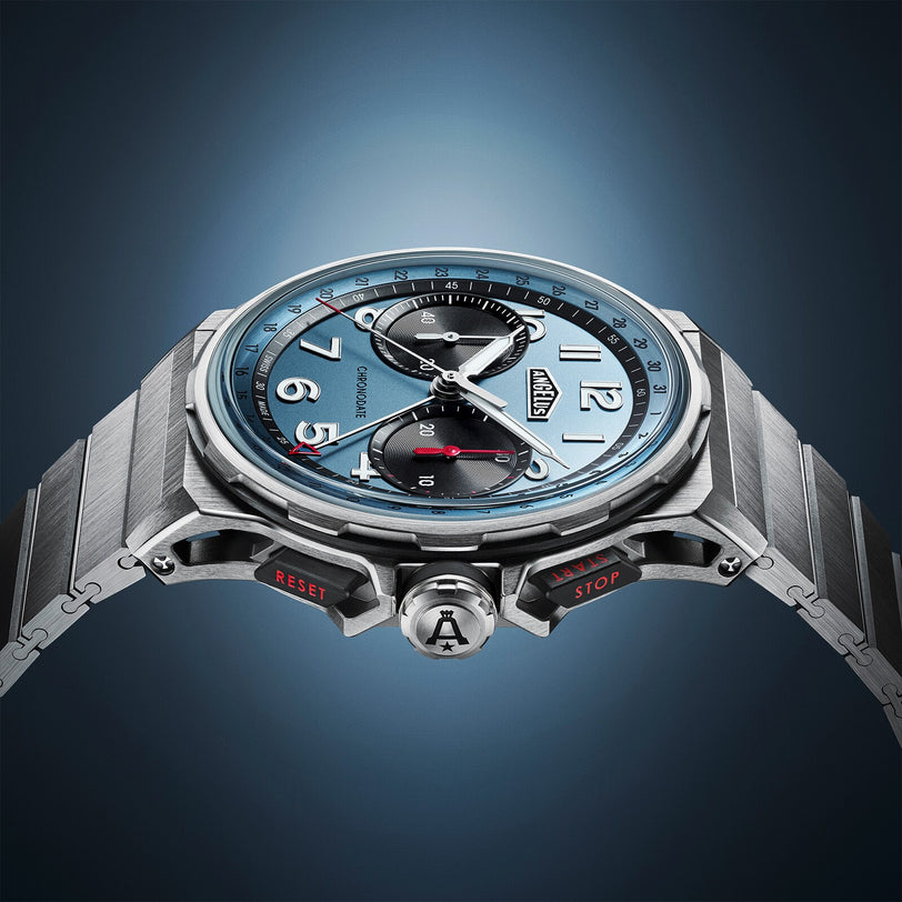 The Angelus Chronodate Titanium Storm Blue Titanium is a sleek luxury wristwatch with a blue face and multiple dials, showcased against a gradient blue background.