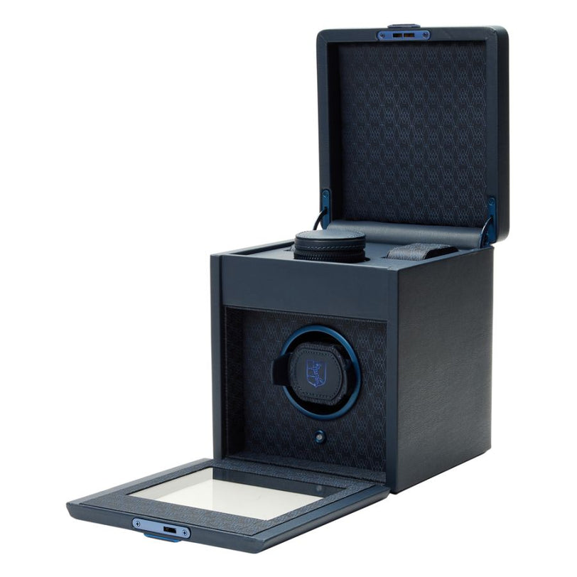 Black watch winder with open lid displaying rotating mechanism and cushioned interior storage compartment.