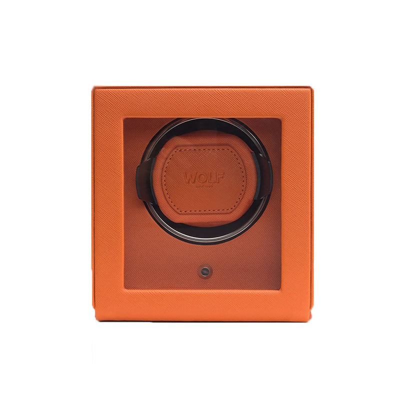 The WOLF Cub Single Watch Winder with Cover features an orange square design and a transparent front panel that displays the watch holder inside.