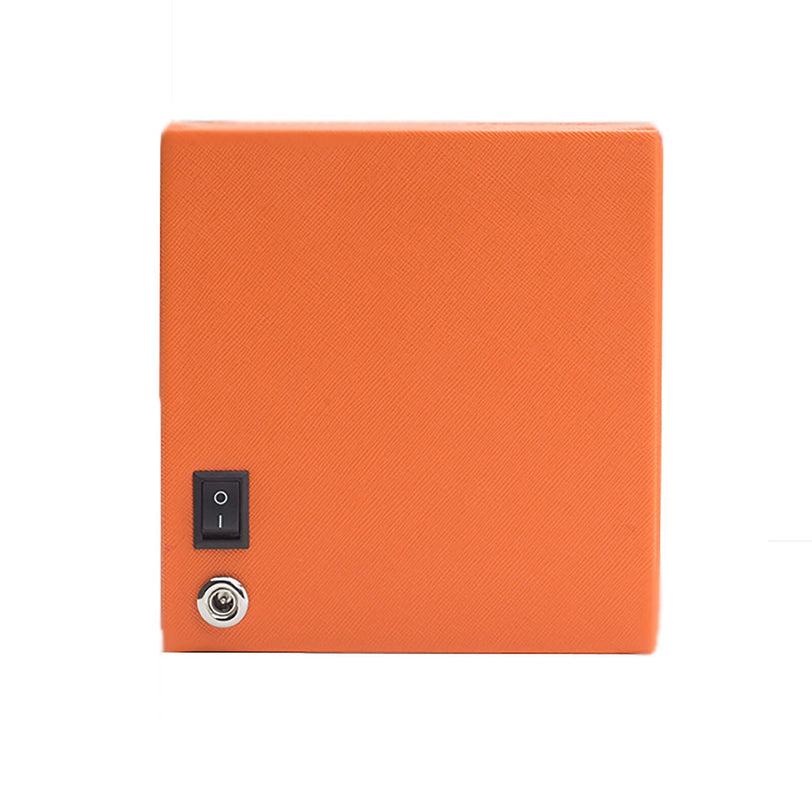 The WOLF Cub Single Watch Winder with Cover is a square orange box featuring a power switch and key lock on its front, displayed against a white background.