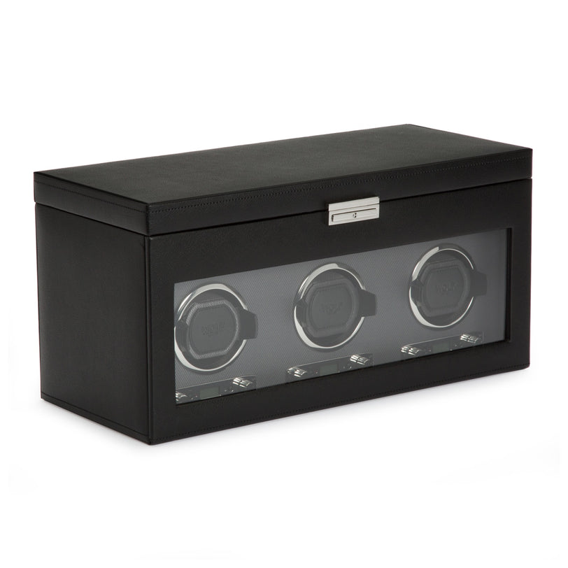 The WOLF Classic Triple Watch Winder with Storage is a black rectangular box featuring a glass front that displays three watch holders inside.
