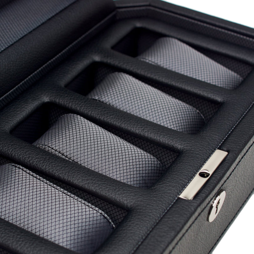 Close-up of the WOLF Windsor 5 Piece Watch Box featuring black leather and grid-patterned cushions in separate compartments.