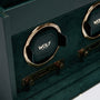 Closeup of a green WOLF British Racing Double Watch Winder with gold accents and the WOLF logo visible on the holder.