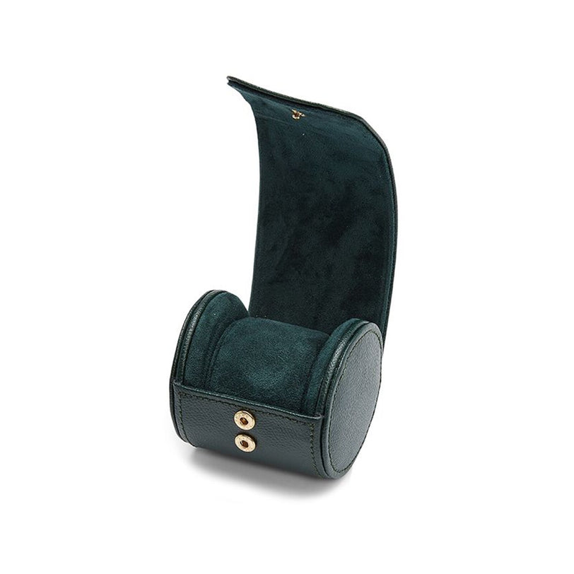 The WOLF British Racing Single Watch Roll features dark green leather in a cylindrical shape with snap buttons, partially open to reveal its soft interior.