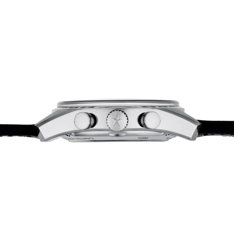 Side view of the Zenith El Primero Limited Edition For Hodinkee wristwatch case in silver, featuring a textured crown and pushers, fitted with a black leather strap, displayed against a white background.