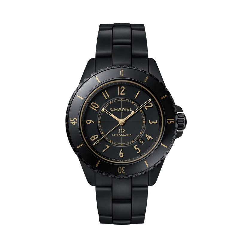 Black Chanel watch with gold accents on a white background