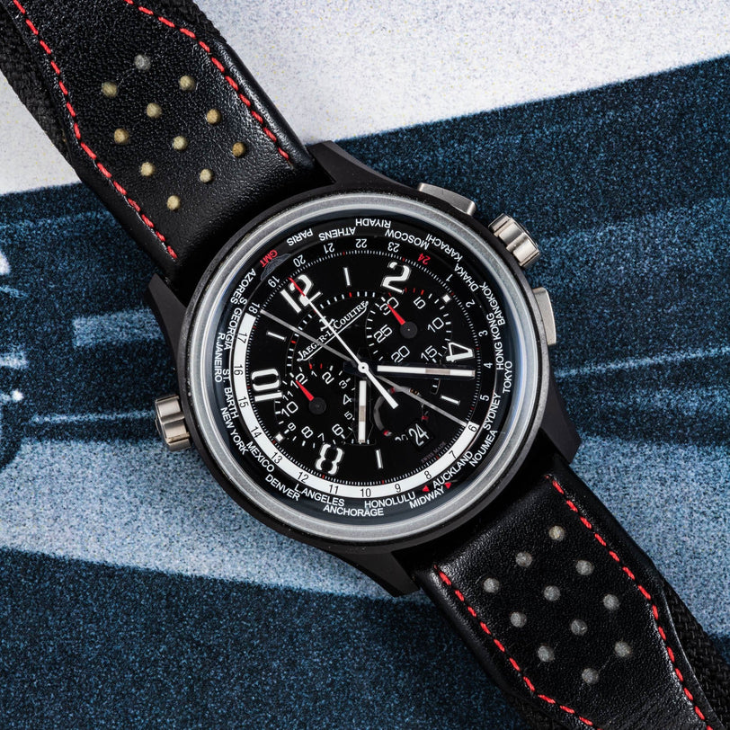 The Jaeger-LeCoultre Amvox 5 World Chronograph is a black Jaeger-LeCoultre watch featuring distinctive red stitching.