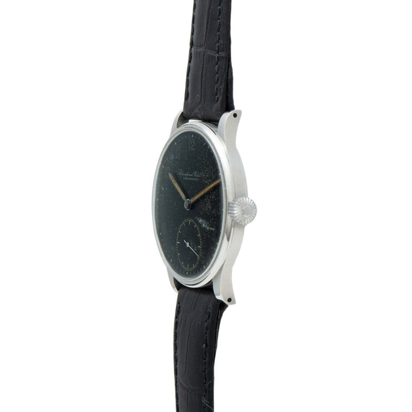 Side view of the IWC Schaffhausen Portugieser wristwatch featuring a black dial and black leather strap.