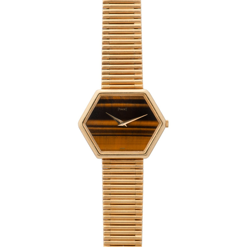 The Piaget Hexagonal Tigers Eye features a gold case, a striped brown face, and a matching gold link bracelet.