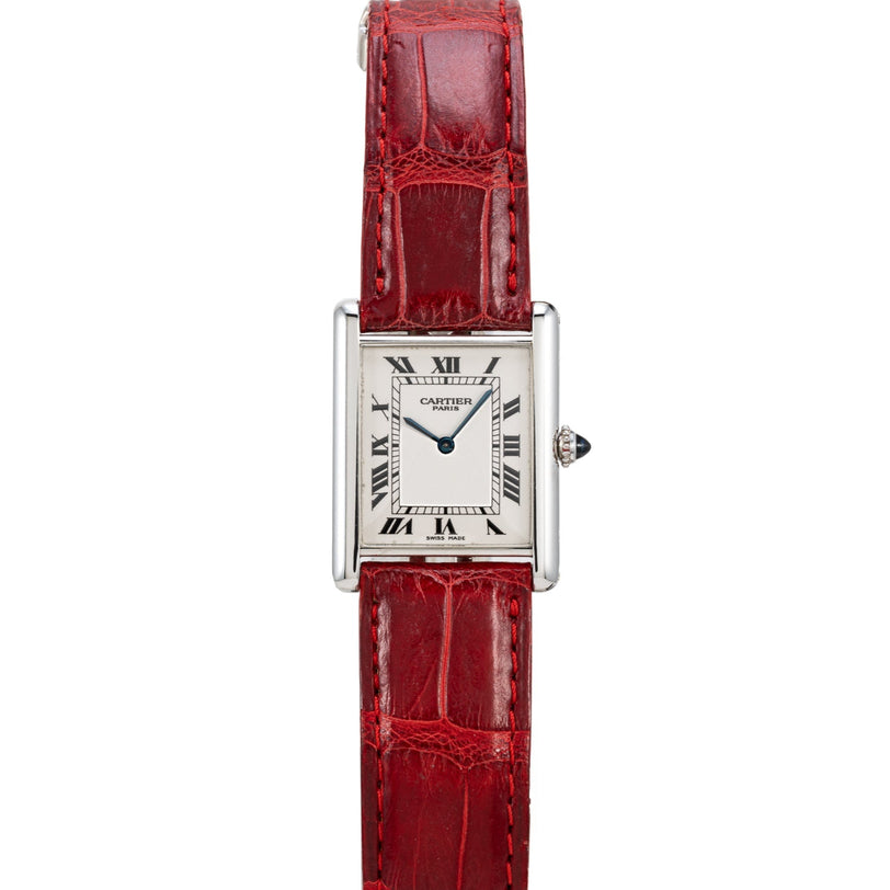 The Cartier Tank Louis watch features a red leather strap and a rectangular face with Roman numerals.