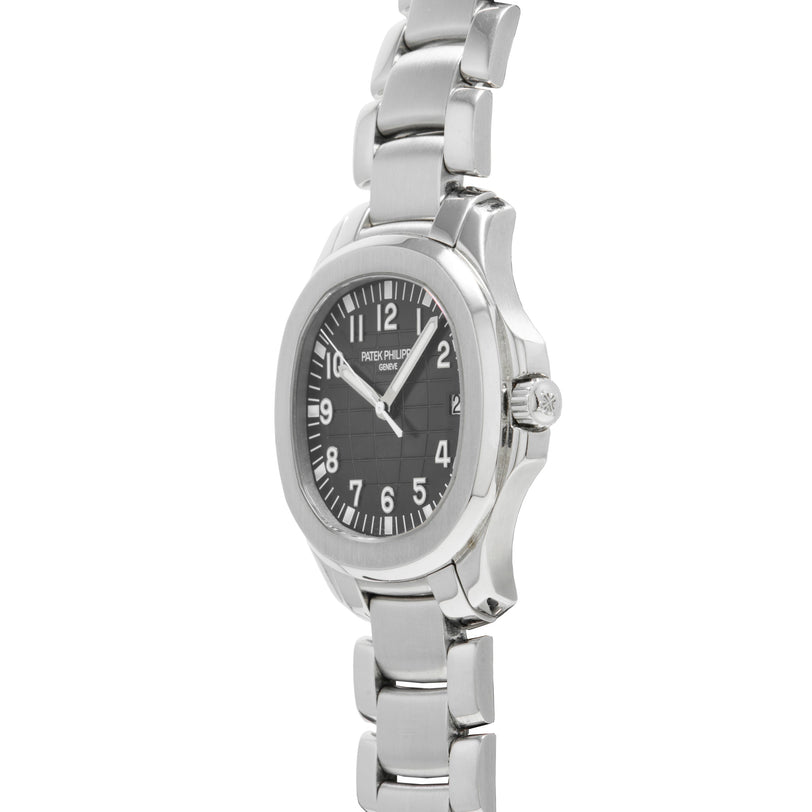 The Patek Philippe Aquanaut wristwatch features a black dial with white numerals and a metal link band, shown from an angled view.