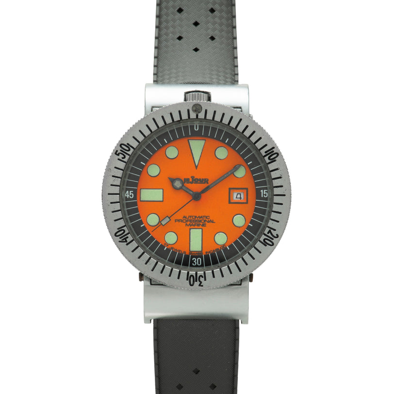 Stainless steel diver watch with orange dial, luminous hour markers, date window, and gray rubber strap.