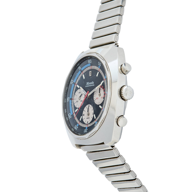Silver chronograph watch with black dial, three subdials, blue tachymeter bezel, and matching metal bracelet.