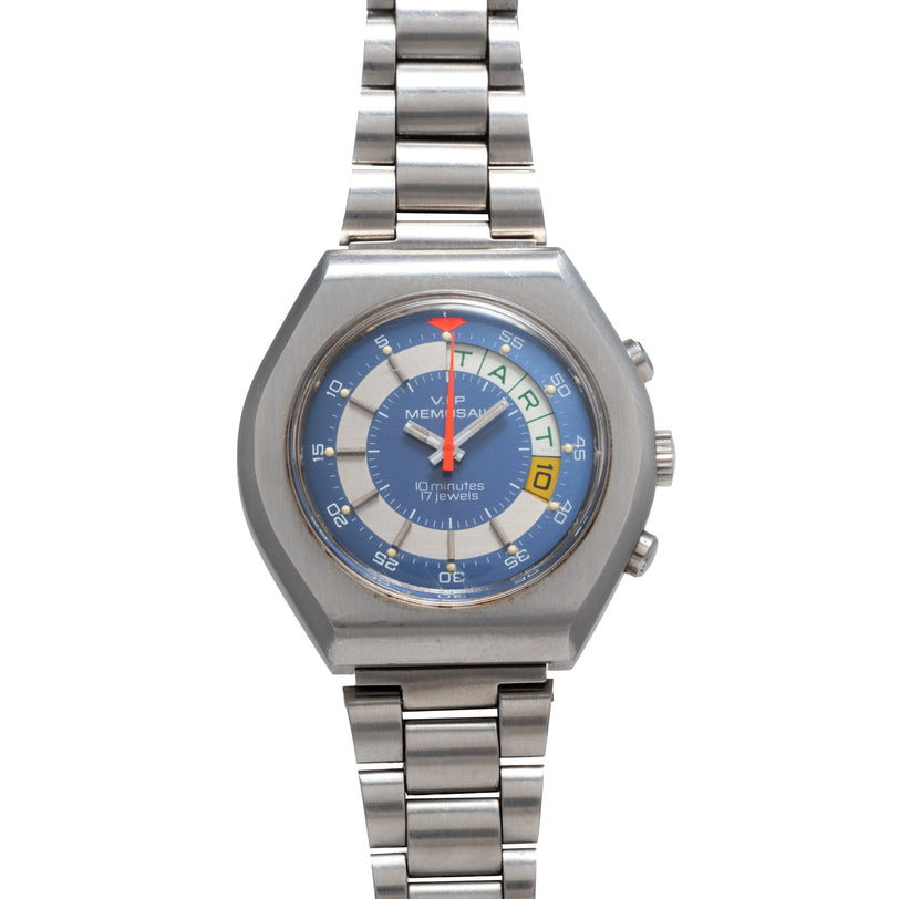 Stainless steel watch with blue dial, red center hand, rotating outer bezel with color segments, and metal bracelet.