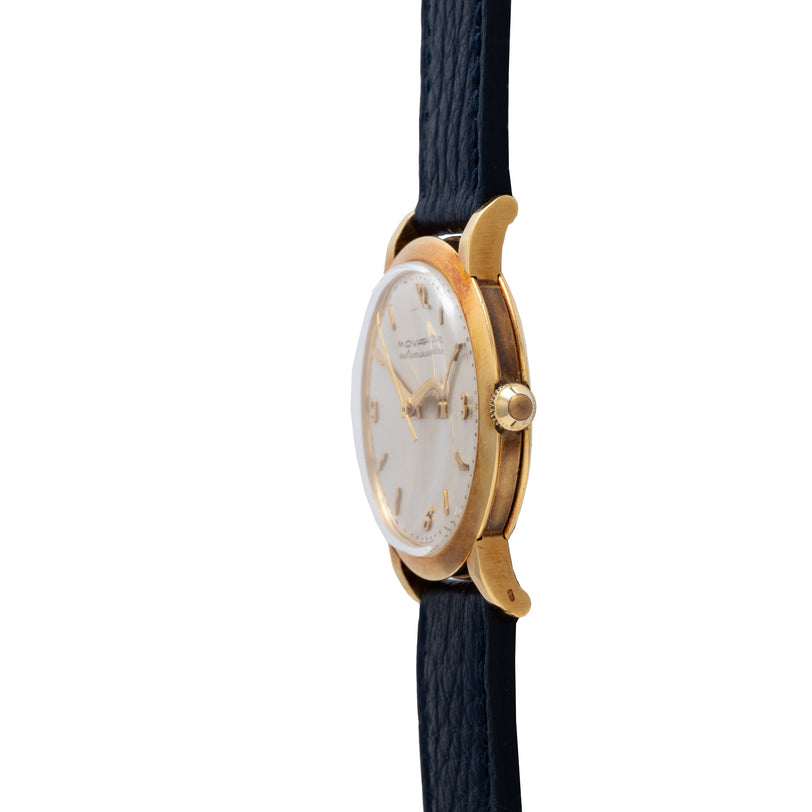 Yellow gold watch with white dial, gold hour markers, and black leather strap.
