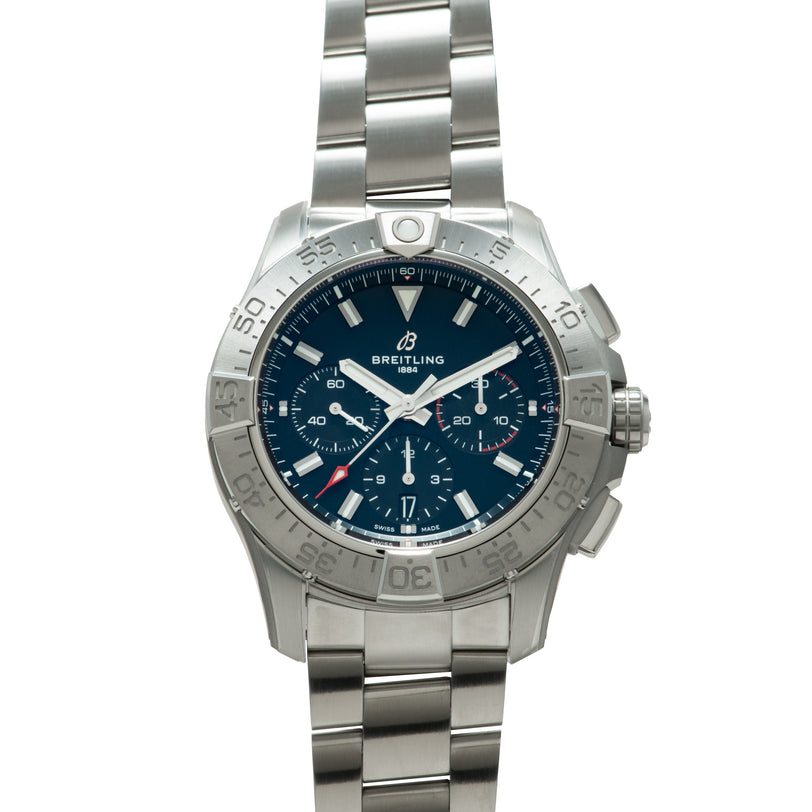 Stainless steel chronograph watch with dark blue dial, white hands, rotating bezel, and metal bracelet.