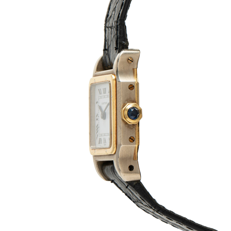 Gold-tone rectangular watch with Roman numeral dial, blue sapphire crown, visible screws on bezel, and black leather strap.