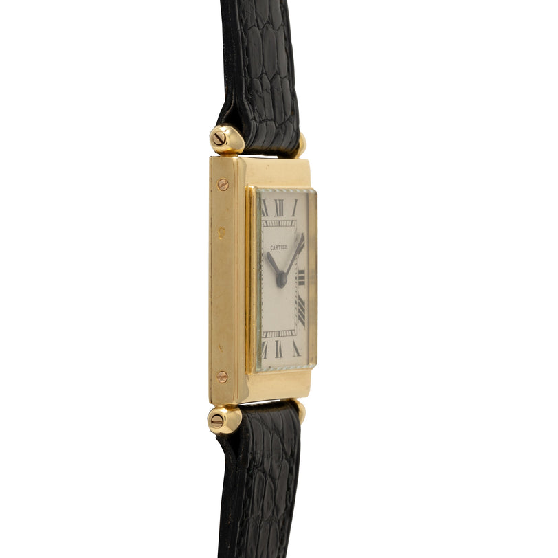 Gold-tone rectangular watch with cream dial, Roman numerals, and black crocodile leather strap.