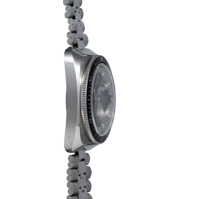 Steel dive watch with round black dial and rotating bezel, attached to multi-link metal bracelet, shown from side view.