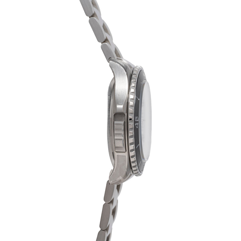 Stainless steel dive watch with dark dial, unidirectional bezel, and matching bracelet shown from the side.