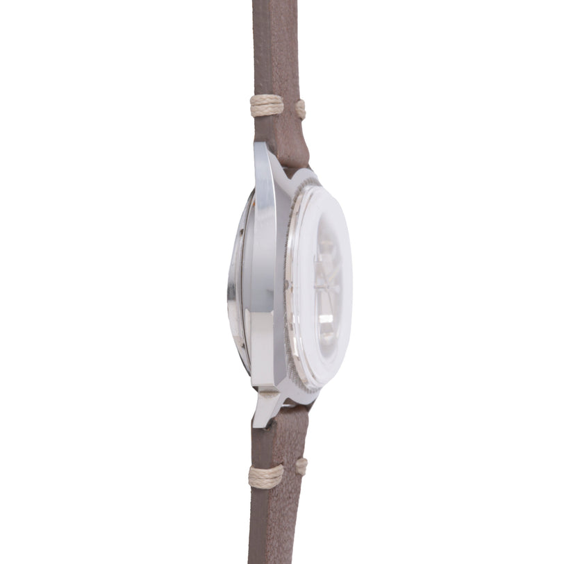 White round watch with cream fabric strap featuring tan rope-style accents, shown from the side.