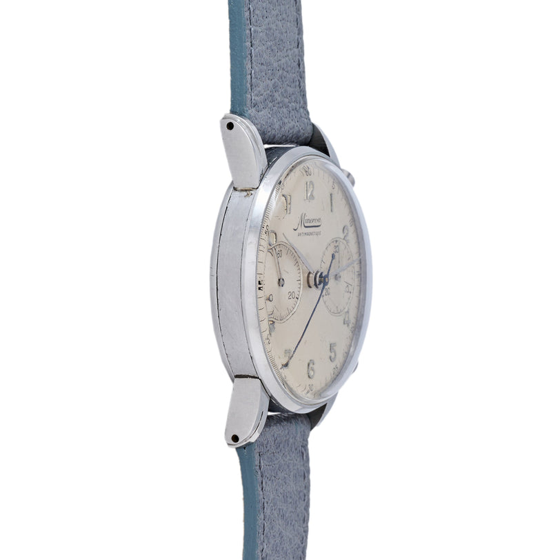 Silver-tone chronograph watch with cream dial, Arabic numerals, and subdials on gray fabric strap.