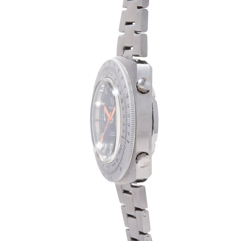 Stainless steel chronograph watch with dark dial, orange hands, calculator bezel, and linked metal bracelet, shown from side
