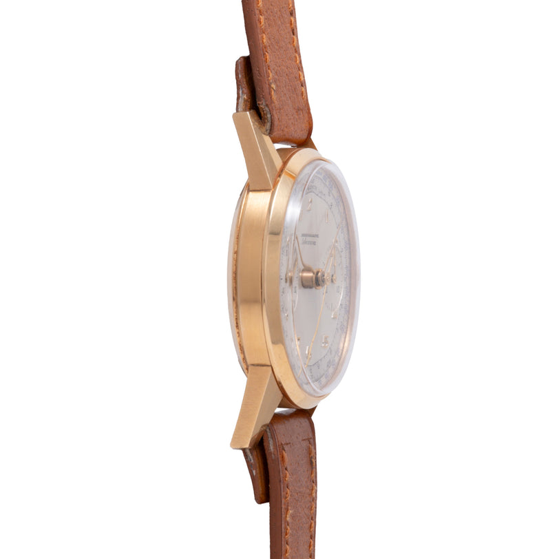 Gold-tone chronograph watch with white dial and brown leather strap shown from side view.