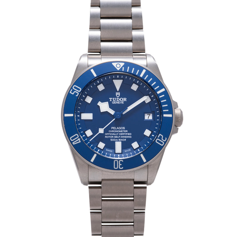Stainless steel watch with blue dial, blue rotating bezel, white hour markers, date window, and matching steel bracelet.