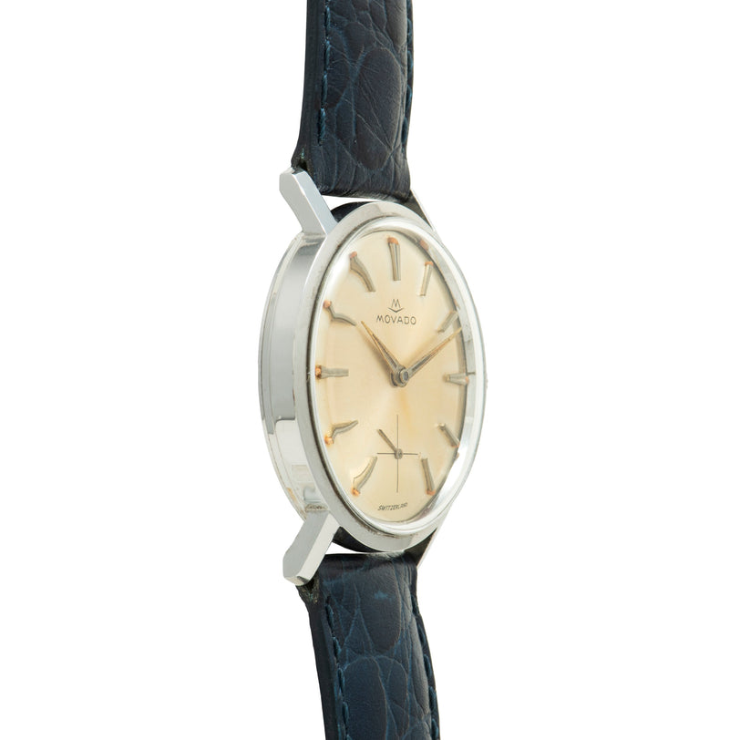 Movado Sub Sea watch with oval stainless steel case, cream dial, applied indices, and dark leather strap.