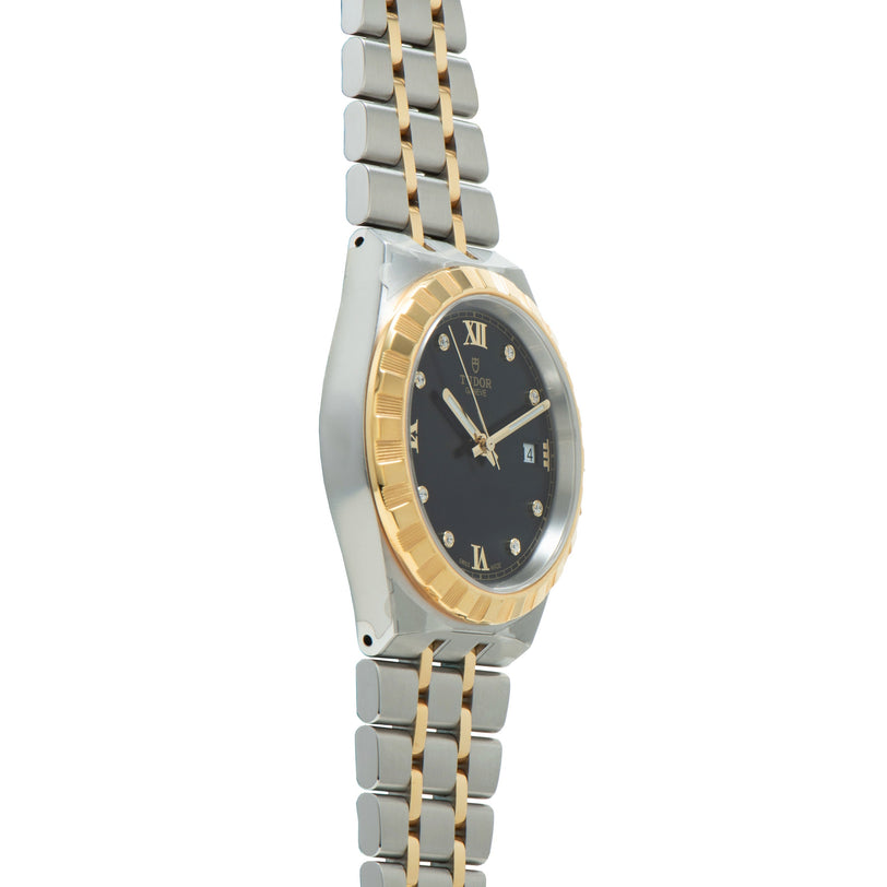 Steel and gold two-tone watch with black dial, Roman numerals, diamond hour markers, and matching bracelet.
