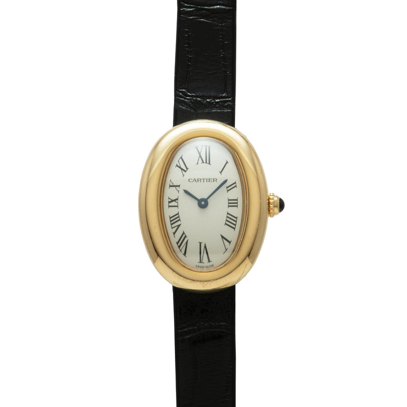 Gold-tone oval watch with cream dial, Roman numerals, and black leather strap.
