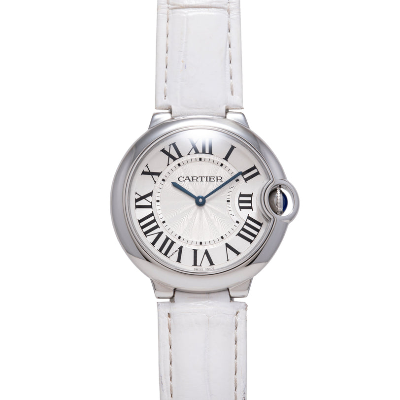 Silver-tone round watch with white dial, Roman numerals, blue hands, and white leather strap.